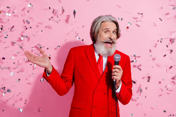 Portrait of attractive cheery trendy funny grey-haired man mc singing song hit pastime night club isolated over pink pastel color background. - Фото, изображение