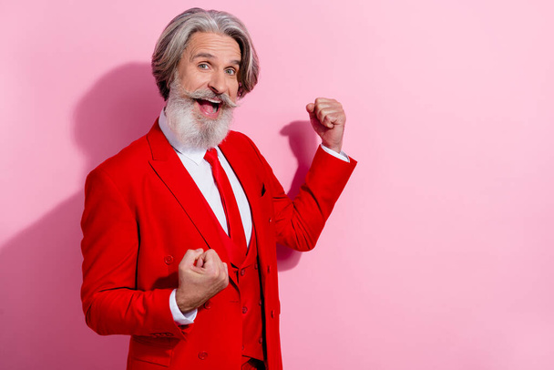 Portrait of positive neat delighted man raise fists celebrate success achieve wear nice costume isolated on pink color background. - 写真・画像