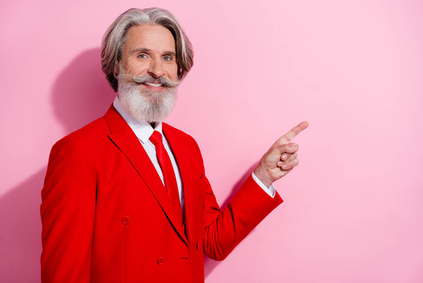 Portrait of handsome positive person toothy smile direct finger empty space offer promo isolated on pink color background. - 写真・画像