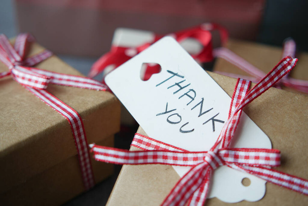 thank you note and gift box on table  - Фото, зображення