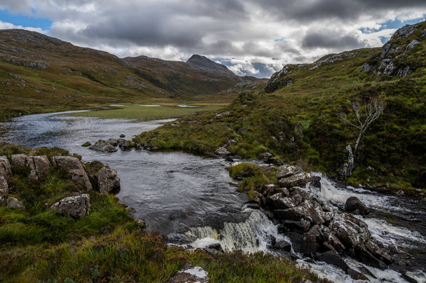Abhainn Bad na h-Achlaise river with Canisp mountain view in the background - Фото, изображение