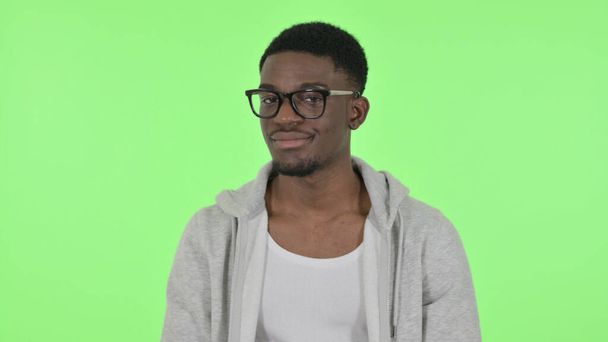 African Man Shaking Head to Reject on Green Background - Photo, image