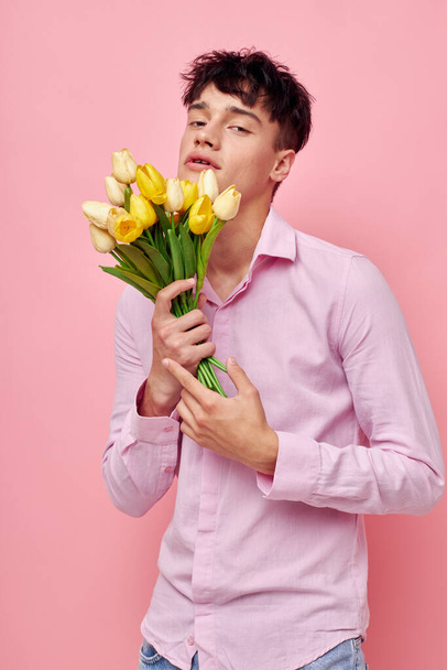 handsome guy Bouquet of yellow flowers romance posing fashion Lifestyle unaltered - Foto, imagen