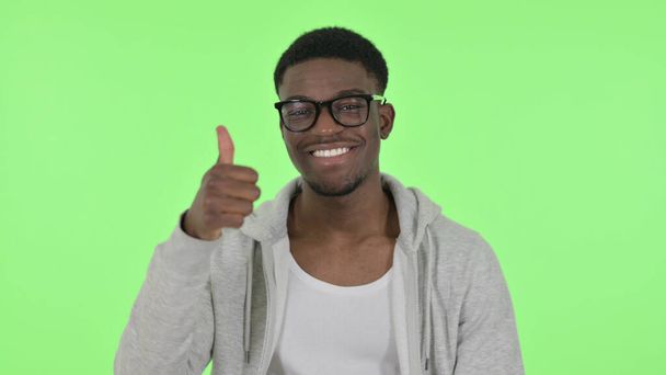 African Man showing Thumbs Up on Green Background - Foto, Imagen