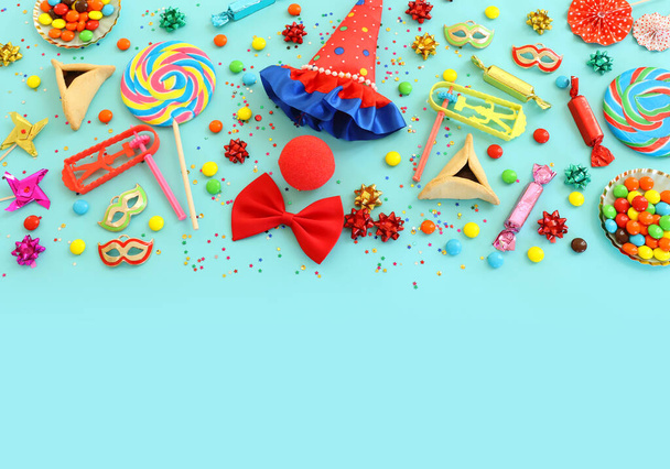 Purim celebration concept (jewish carnival holiday) over blue background. Top view, flat lay - Fotó, kép