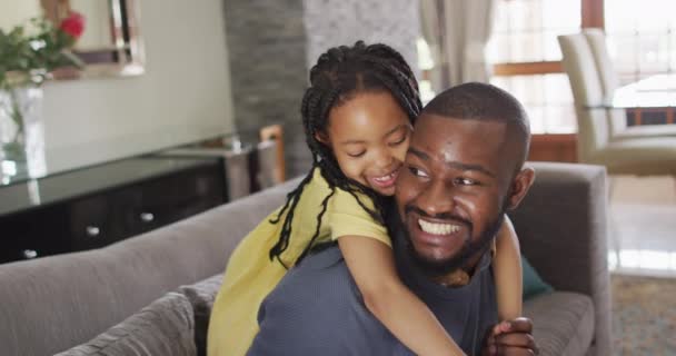 Happy african american daughter and father fooling around at home. quality family time together at home. - Felvétel, videó