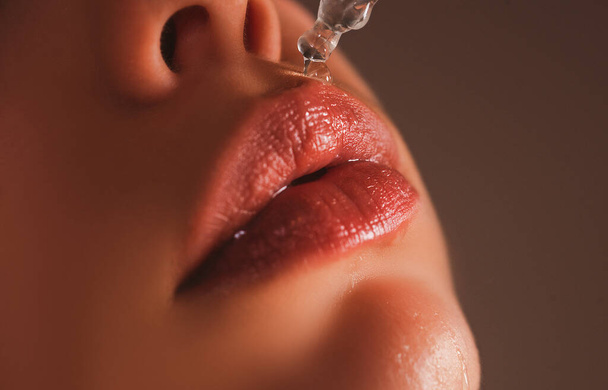 Lips care. Hyaluronic acid. Lip oil. Hygienic lipstick. Herpes treatment. - Foto, imagen