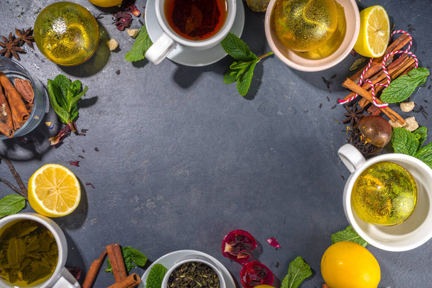 Various tea ball bombs. Assortment of different tea balls with dried tea, cups, lemon and mint, top view copy space. Trendy modern tea variety - Foto, immagini