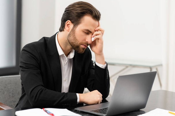 Tired male office employee suffering from strong headache - Foto, Imagem