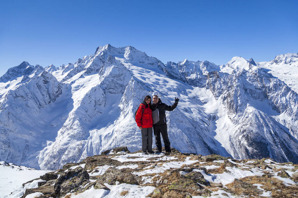 Couple in love on the background of snowy mountains - Photo, Image
