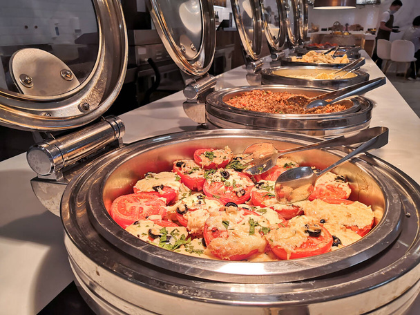 Choice of salads, buffet. Large selection of dishes in the restaurant, salads, meat barbecue, cake - Foto, afbeelding
