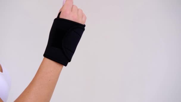 Black Wrist and Thumb Brace stabilizer on woman hand - Footage, Video