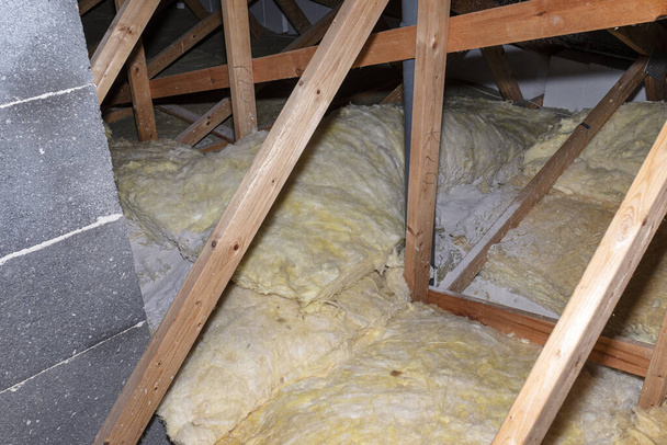 Glass wool placed on pipes in domestic ventilation with heat recovery, pipes placed on a roof truss. - Photo, image