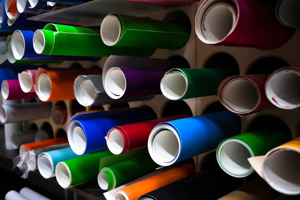 Decorative film for window display decoration in round tubes on the shelf. - Foto, afbeelding