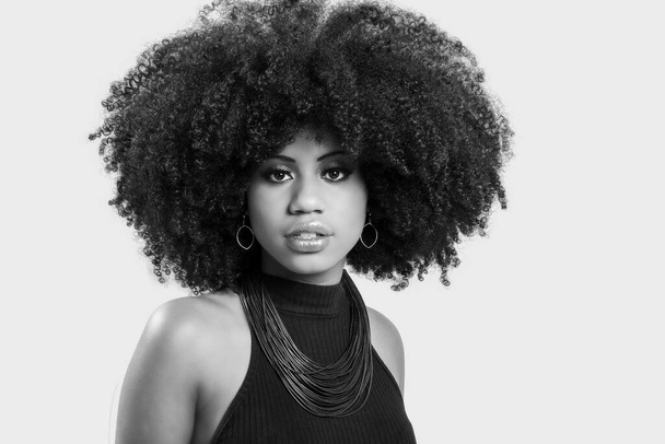 portrait of a young black woman with great afro hair looking at camera. - Foto, Imagen
