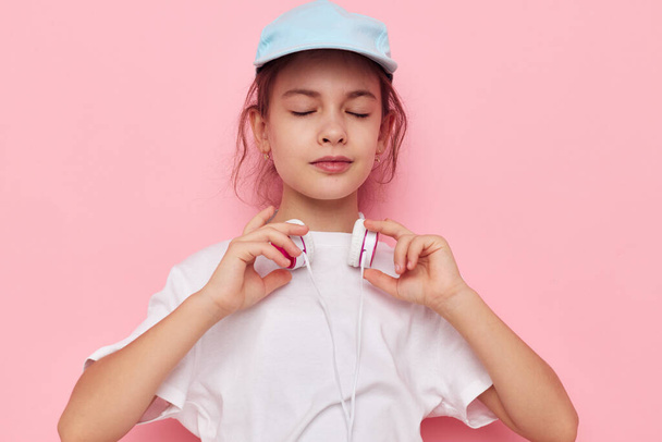 pretty young girl wearing headphones posing emotions isolated background - Valokuva, kuva