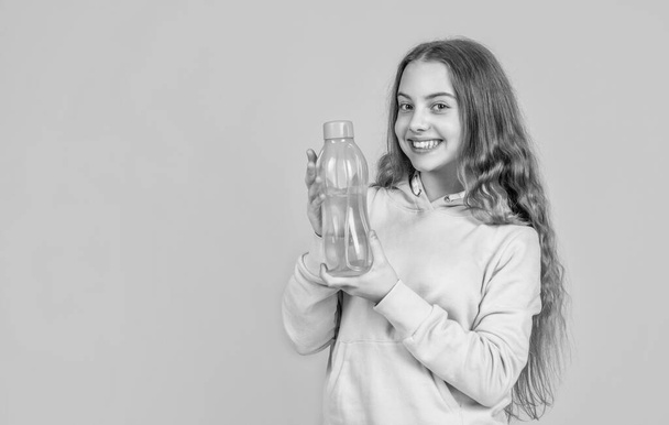 take care of you. athletic kid care of water balance in body. hydration. feel thirsty. protein and vitamin bottle. happy and healthy teen girl. fit child drink water after training. sport is life - Foto, Imagen