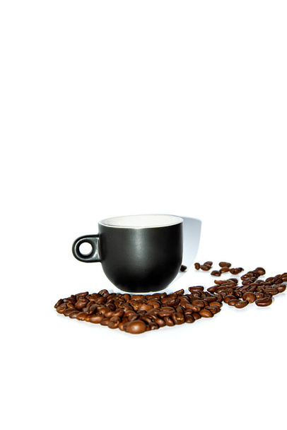 Black heart shaped coffee cup with scattered beans on a white background. Front view. Isolate. Lifestyle. - Photo, Image