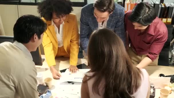 Multiracial coworkers' team and colleagues brainstormed, discussing marketing strategy, ideas collaboration, and business project planning at an office's conference table in staff meeting workplace. - Footage, Video
