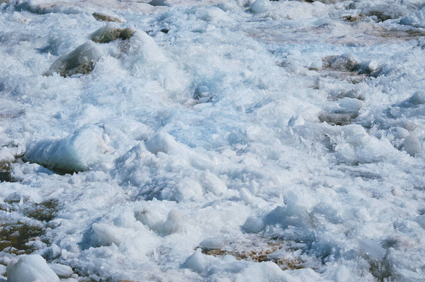 Melting ice on the river in spring. Ice drift time. Natural structure. Needles in the sun. - 写真・画像