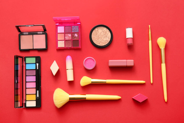 Decorative cosmetics on red background - Foto, afbeelding