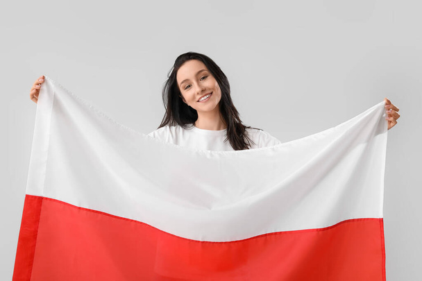 Mulher bonita com bandeira da Polônia no fundo claro - Foto, Imagem