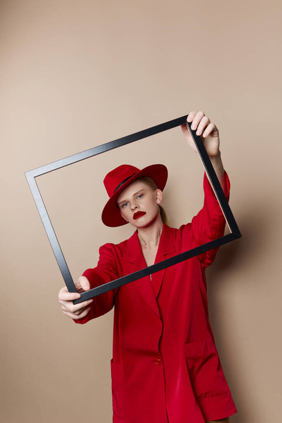 fashionable woman with wooden frame posing red suit Lifestyle posing - Фото, изображение