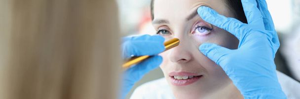 Doctor shines laser into patient eye closeup - 写真・画像