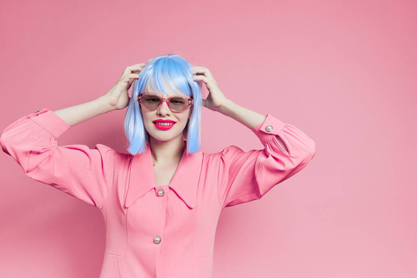 portrait of a woman in sunglasses wears a blue wig makeup isolated background - 写真・画像