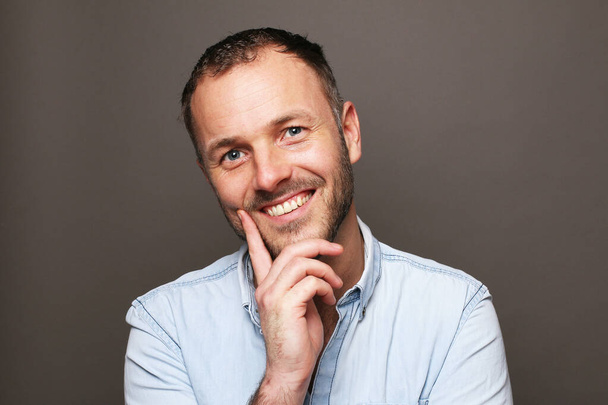 Portrait of a beautiful happy man in front of a colored background - Fotoğraf, Görsel