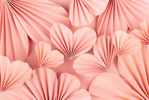 Valentines day festive background in asian style - pink paper hearts of folded fans on gentle pastel pink color backdrop as pattern, texture, top view. - Foto, Imagem