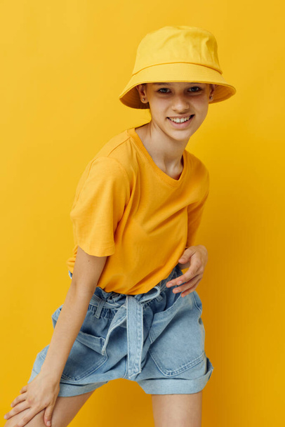 young beautiful woman fashion in yellow t-shirt posing fashion in panama yellow background - Fotoğraf, Görsel