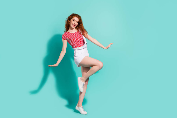 Full length body size view of nice pretty cheerful girl dancing posing having fun isolated bright blue color background. - 写真・画像