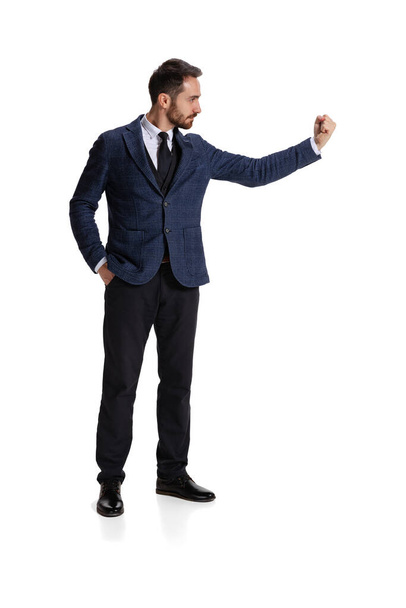 Full-length portrait of businessman showing warning fist isolated over white background - Foto, immagini