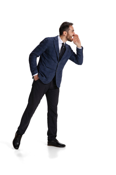 Full-length portrait of man, office worker whispering information isolated over white background - Photo, Image