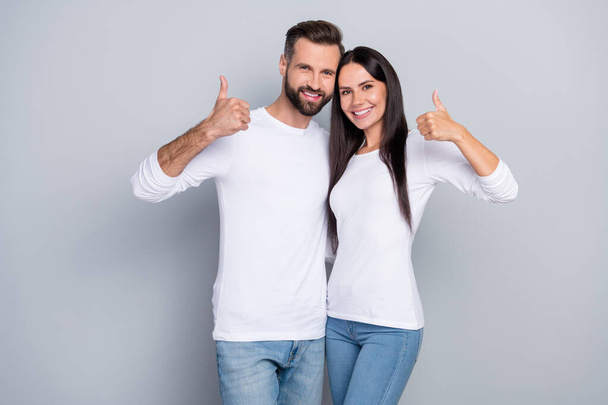 Photo of charming cute sister brother wear white shirts smiling showing two thumbs up isolated grey color background. - Photo, image