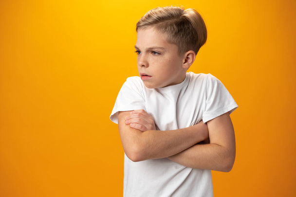 Portrait of naughty little boy against yellow background - Фото, изображение