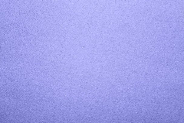 Texture of paper surface used for watercolor or aquarel paintings. Full frame background toned in very peri, color of year 2022. . Copy space. Vertical orientation. - Photo, image