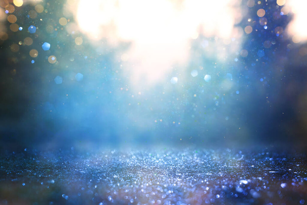 blurred abstract photo of light burst among trees and glitter bokeh lights - 写真・画像