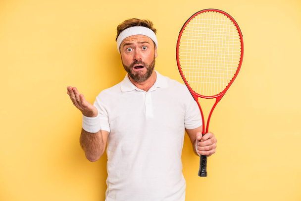 middle age man feeling extremely shocked and surprised. tennis concept - Photo, Image