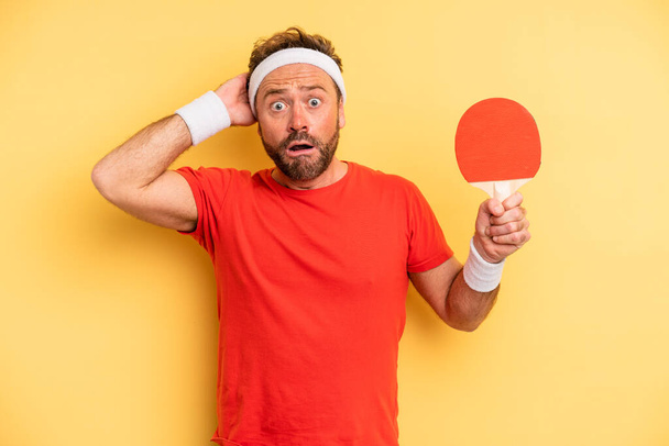 middle age man feeling stressed, anxious or scared, with hands on head. ping pong concept - Photo, Image