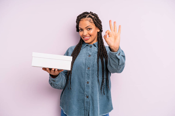 Musta afro nainen onnellinen, osoittaa hyväksyntää kunnossa ele. paketit laatikko käsite - Valokuva, kuva