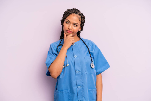 black afro woman thinking, feeling doubtful and confused. nurse concept - Фото, зображення