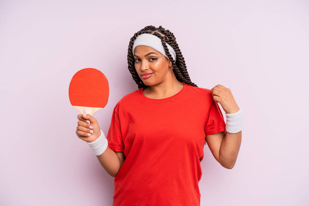 black afro woman looking arrogant, successful, positive and proud. ping pong concept - 写真・画像