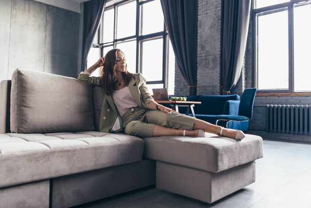 Business woman sitting relaxed on the sofa - Valokuva, kuva