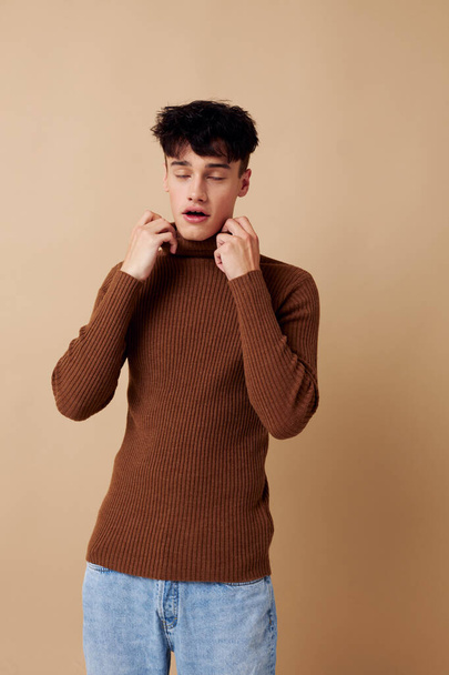 handsome guy stylish hairstyle brown turtleneck light background unaltered - Foto, immagini
