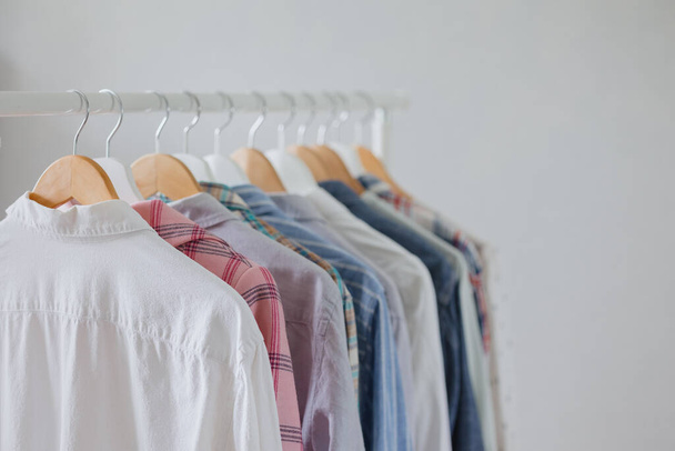 dressing room or rail with clothes on hangers shirts and dresses. a clothing store or boutique. a female stylist picks up a wardrobe - Φωτογραφία, εικόνα