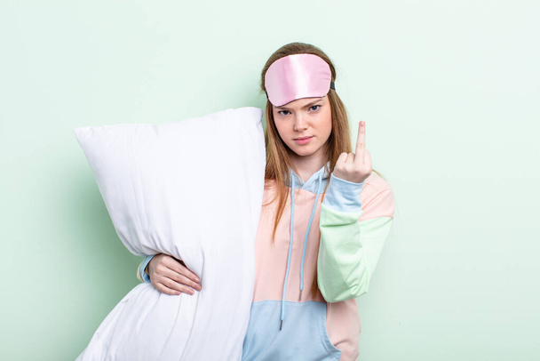 redhair woman feeling angry, annoyed, rebellious and aggressive. pajamas and pillow concept - Fotografie, Obrázek