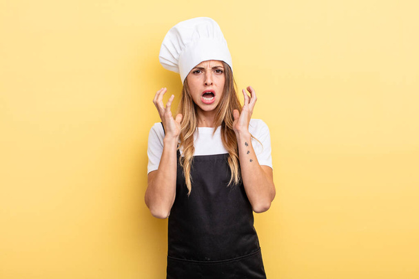 pretty woman screaming with hands up in the air. chef concept - 写真・画像