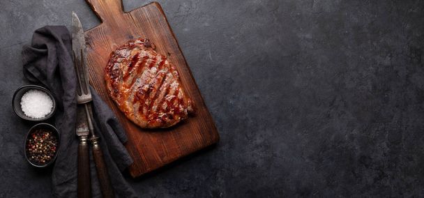 Grilled beef steak with spices. On cutting board. Top view flat lay with copy space - Photo, Image